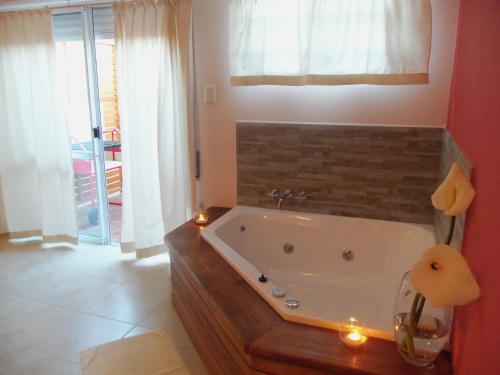 a bathroom with a bath tub with candles in it at Epuyen in Chascomús