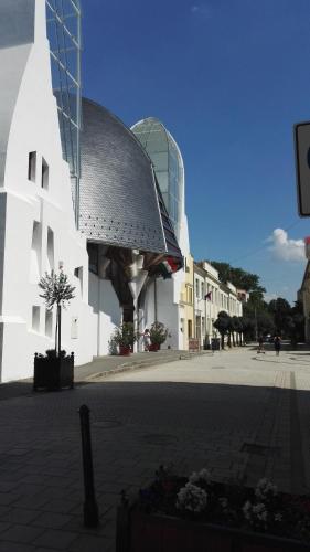 a building with a glass dome on top of it at Csipke Apartman in Makó
