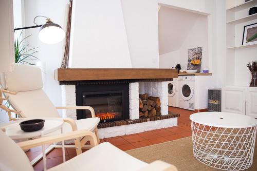 a living room with a fireplace and a table and chairs at MontEstoril Sptaz in Estoril