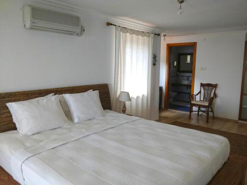 A bed or beds in a room at Zephyros Hotel