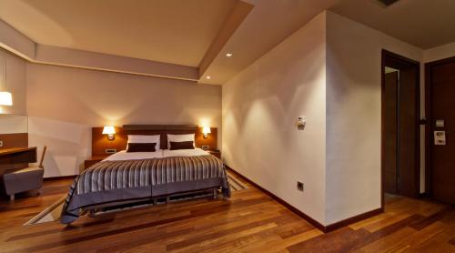 a large bedroom with a bed and a desk at Hotel Kaj in Marija Bistrica
