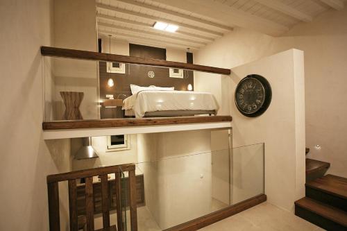 a room with a bed and a clock on a wall at Atlantis Beach Residence in Super Paradise Beach