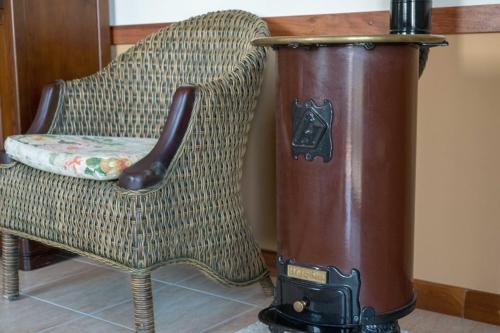 a chair with a water cooler sitting next to a chair with a chair at Quinta Sta Luzia Carrascal in Vila Flor
