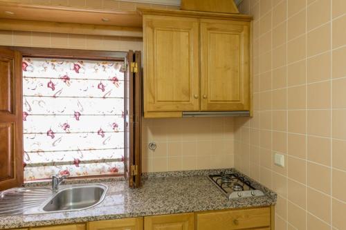 a kitchen with a sink and a window at Quinta Sta Luzia Carrascal in Vila Flor