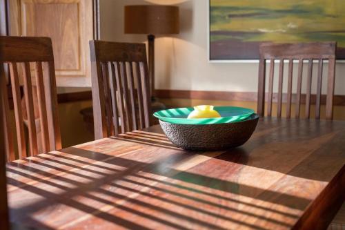 a wooden table with a green bowl on top of it at Quinta Sta Luzia Carrascal in Vila Flor