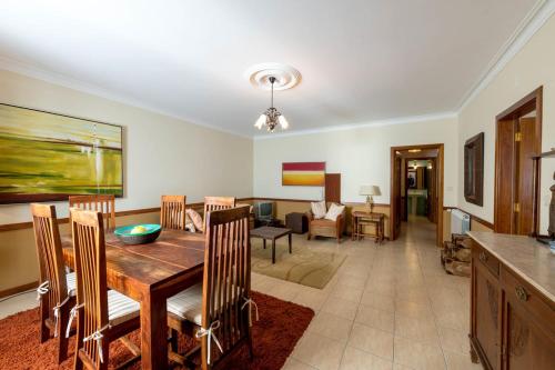 a dining room and living room with a table and chairs at Quinta Sta Luzia Carrascal in Vila Flor