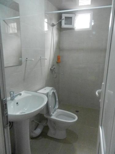 a bathroom with a white toilet and a sink at guest house katia tbilisi in Tbilisi City