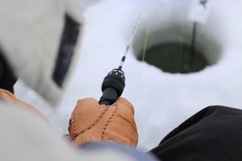a person holding a microphone in front of a white object at Aaron's on the Lake in Matlock