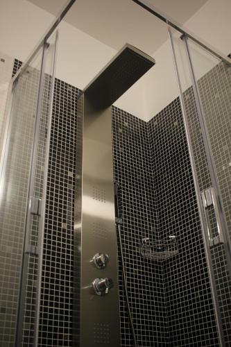 a shower with a glass wall and a shower at Hotel Orazio in Venosa