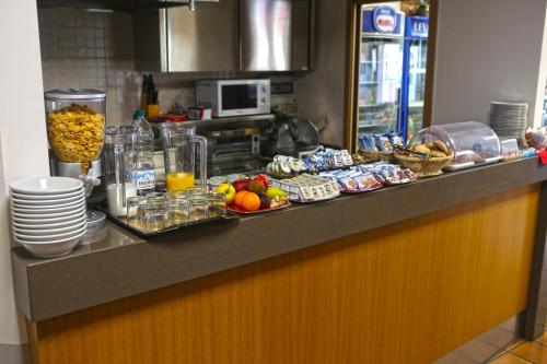 a kitchen counter with a buffet of food and drinks at Albergo Gusmeroli in Tirano