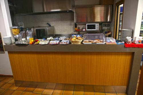 a kitchen with a counter with food on it at Albergo Gusmeroli in Tirano