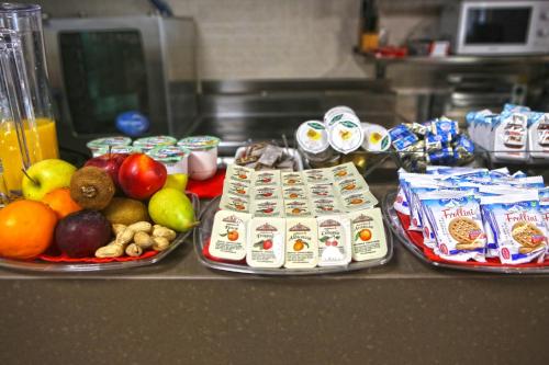 two plates of food on a counter with fruit and eggs at Albergo Gusmeroli in Tirano