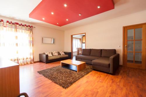 a living room with a couch and a table at Deluxe Apart in Furadouro