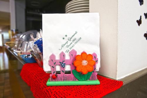 a birthday cake with a flower on top of a table at Albergo Gusmeroli in Tirano