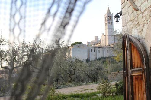 a building on a hill with a clock tower at La Casa Di Famiglia in Assisi