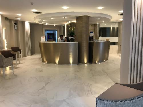 a lobby with a reception desk in a building at Hotel Villa Paola in Rimini