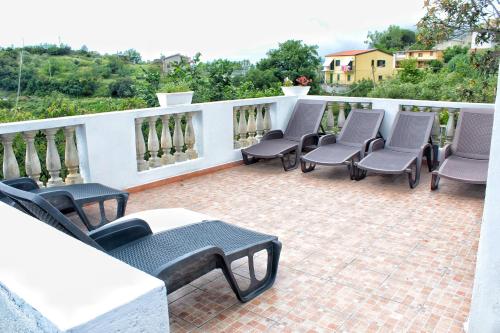 a group of chairs and tables on a patio at B&B Verzavò in Cetraro