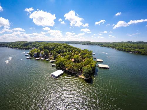 an aerial view of a lake with houses and trees at Point View Resort in Camdenton