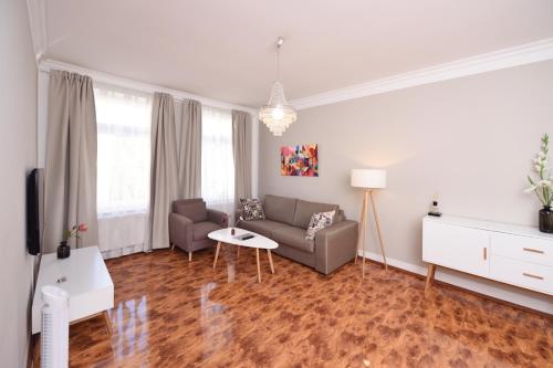 a living room with a couch and a table at Apartments-Leipzig in Leipzig