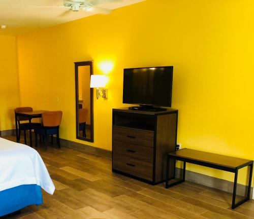 a bedroom with a bed and a television on a dresser at Days Inn by Wyndham Port Aransas TX in Port Aransas