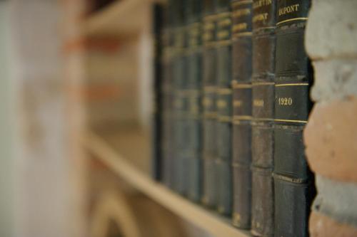 a row of books on shelves in a library at Hôtel Les Chevaliers in Laon