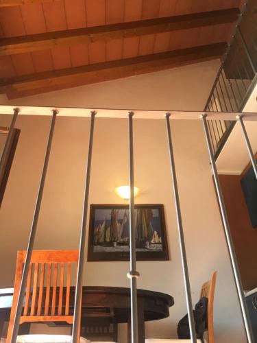 a room with a staircase with a table and a picture on the wall at Casa del porticciolo di Capraia in Capraia