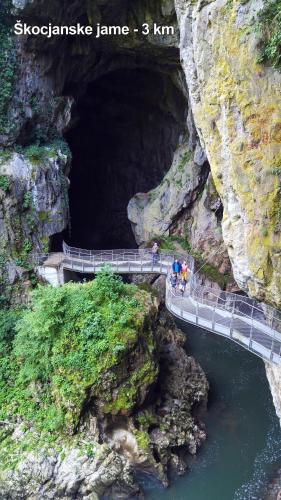 a group of people standing in front of a cave at Hotel Malovec in Divača