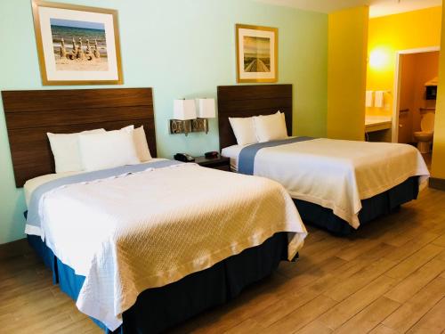 a hotel room with two beds in a room at Days Inn by Wyndham Port Aransas TX in Port Aransas