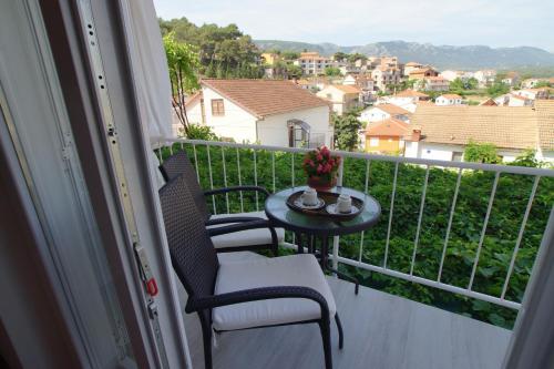 a balcony with a table and chairs and a view at Villa Volga in Jelsa