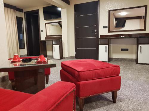 a living room with a couch and a red stool at Villa Aroma 2 in Orašje