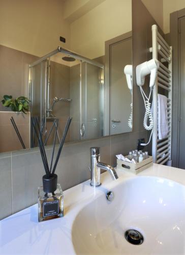 a bathroom with a white sink and a mirror at Hotel Aloisi in Lecce