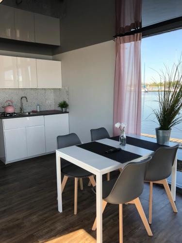 a kitchen and dining room with a table and chairs at Houseboat Porta Mare III in Świnoujście