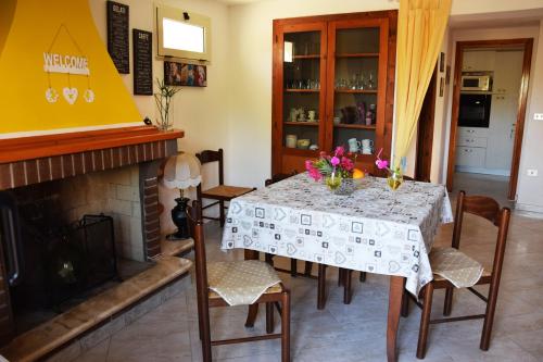 a dining room with a table and a fireplace at Chez Pierre in Santa Maria Navarrese
