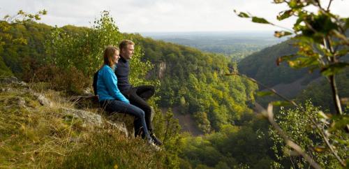 a man and a woman sitting on top of a mountain at The Garden Hill Hotel in Vallåkra