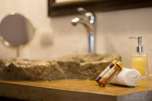 a bathroom counter with a sink and a roll of towels at Casa Del Reloj in Medellín