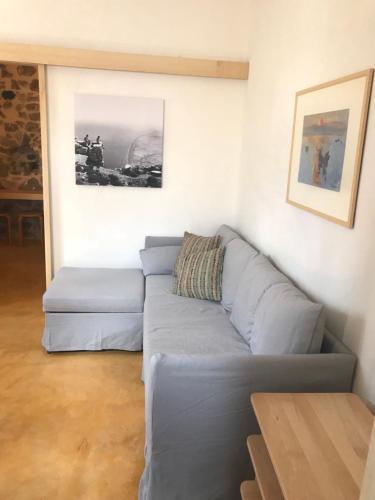 a living room with a couch and a table at Canava Villas #3 in Santorini in Emporio Santorini