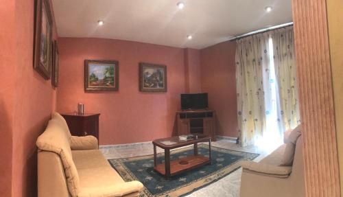 a living room with a couch and a table at Hospedium Hotel Twist in Torredonjimeno