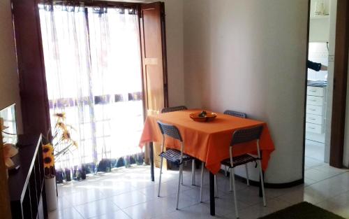 a dining room table with an orange table cloth on it at Foz do Arelho Beach Apartment "Blue" in Foz do Arelho