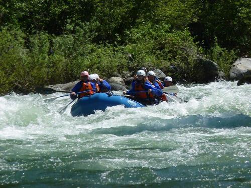 a group of people in a raft in a river at Logden Lodge in Nelson