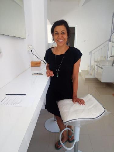 a woman in a black dress standing at a counter at Wika Bali Beach House in Jimbaran