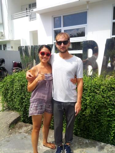 a man and a woman standing in front of a house at Wika Bali Beach House in Jimbaran