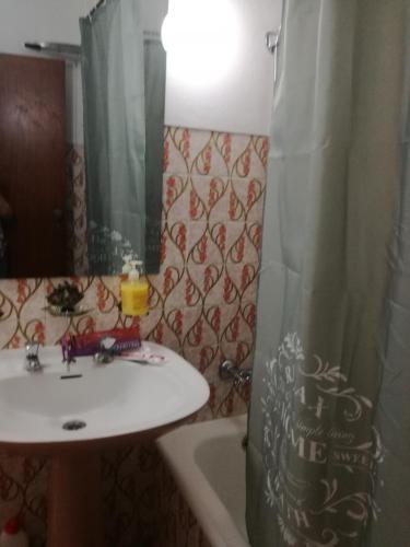 a bathroom with a sink and a shower curtain at Arronches Villa in Arronches
