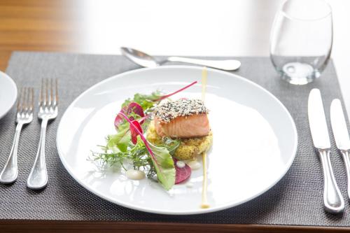 a white plate with food on a table at Sofitel Montevideo Casino Carrasco & Spa in Montevideo