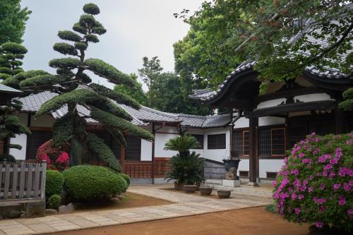 a building with a tree in front of it at Mokkoan in Tokyo