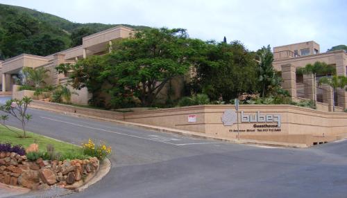 a road in front of a building with a sign at Bubez Guesthouse in Barberton