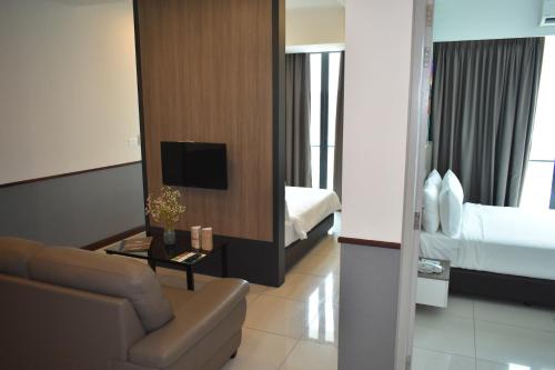 a living room with a couch and a bed at D'Wharf Hotel & Serviced Residence in Port Dickson