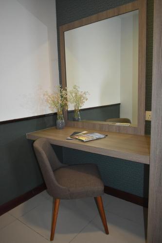 a desk with a chair and a mirror at D'Wharf Hotel & Serviced Residence in Port Dickson