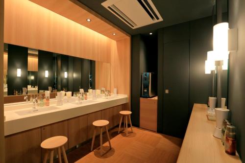 a bathroom with two sinks and a large mirror at Candeo Hotels Nara Kashihara in Kashihara