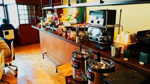 a bar in a restaurant with a counter top at Tabist THE GREEN OTARU in Otaru