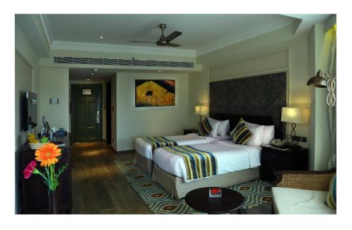a hotel room with a bed and a couch at Fragrant Nature Kochi - A Five star Classified Hotel in Cochin